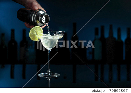 Cocktail "Margarita" on a black table in a bar. 79662367