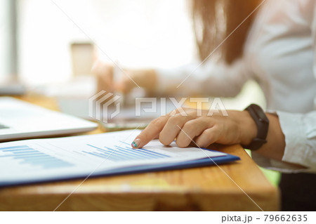 Cropped shot of female finger pointing on financial papers Cropped shot of female finger pointing on financial papers 79662635