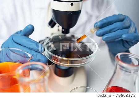 female laboratory assistant adjusts microscope research chemical solutions science 79663375