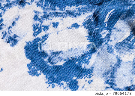 Tie-dye cotton fabric texture blue and white paint colors. Ancient resist-dyeing textile coloring technique,trendy cloth 79664178