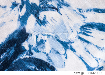 Tie-dye cotton fabric texture blue and white paint colors. Ancient resist-dyeing textile coloring technique,trendy cloth 79664183