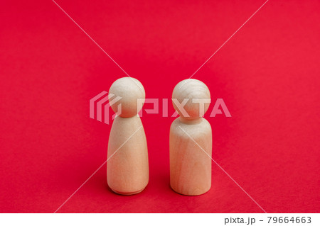 Wooden figurines of man and woman on red backdrop, relationship, communication problems. Happy couple concept 79664663