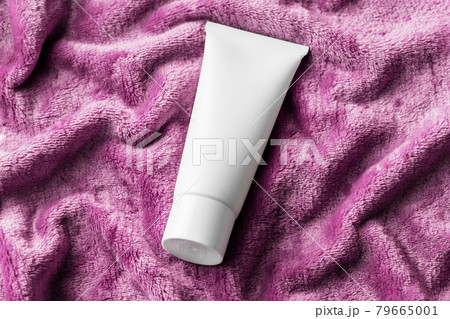 Cosmetic tube, white cream lotion on fuzzy surface. Beauty product mockup package, advertising brand, shampoo, cleanser, on cozy plush fabric texture. Winter skin care moisturizing cosmetic 79665001