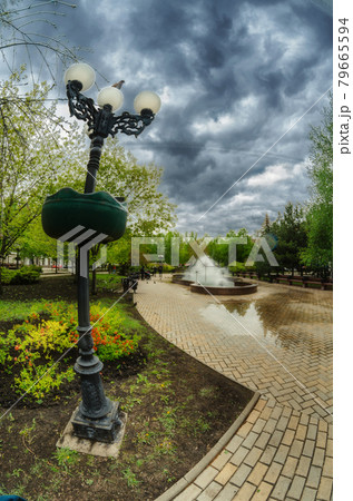 Cloudy weather on a summer day in the city park near the fountain. 79665594