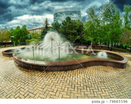 Cloudy weather on a summer day in the city park near the fountain. 79665596