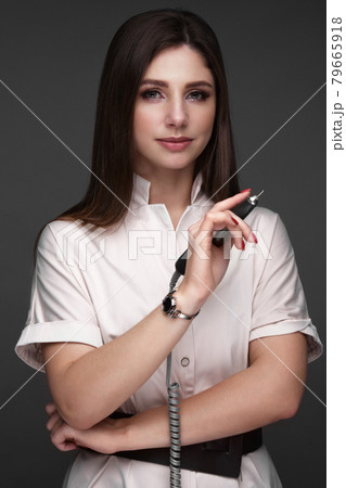 Manicurist in working form with tools in hand. Nail photo content Manicurist in working form with tools in hand. Nail photo content 79665918