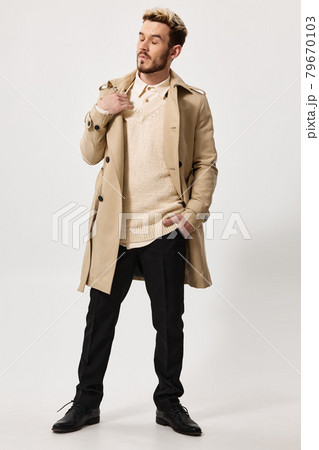 a man in a first coat and a sweater, do not touch his shoulder and look to the side hand in his pocket a man in a first coat and a sweater, do not touch his shoulder and look to the side hand in his pocket 79670103