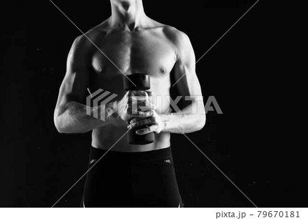 sporty man with dumbbells in hands pumping up muscles exercises dark background sporty man with dumbbells in hands pumping up muscles exercises dark background 79670181