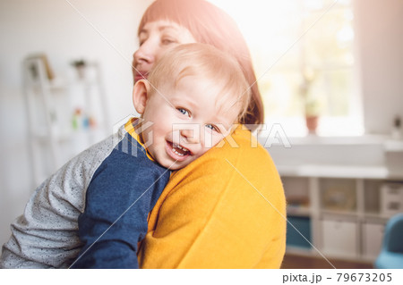 Happy mother embracing her smiling son carefully 79673205