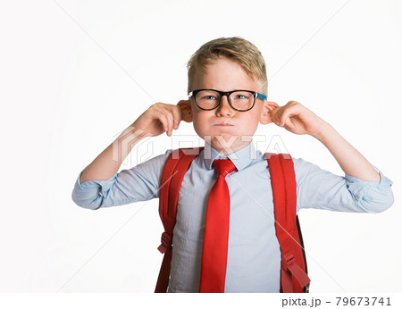 School kid boy making monkey face. Funny silly child boy grimacing isolated on white background. Pupil with big ears listening. Emotional face of caucasian blond kid with freckles looking at camera. School kid boy making monkey face. Funny silly child boy grimacing isolated on white background. Pupil with big ears listening. Emotional face of caucasian blond kid with freckles looking at camera. 79673741