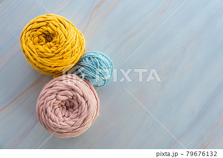 Top view of round colorful skeins of cotton yarns for macrame knitting with blank space. Top view of round colorful skeins of cotton yarns for macrame knitting with blank space. 79676132