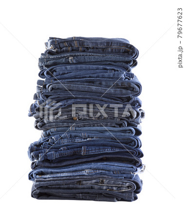 Stack of blue jeans isolated on white background with clipping path Stack of blue jeans isolated on white background with clipping path 79677623