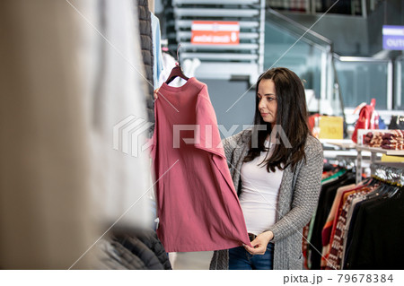 Young woman shopping in the clothes store, shop concept 79678384