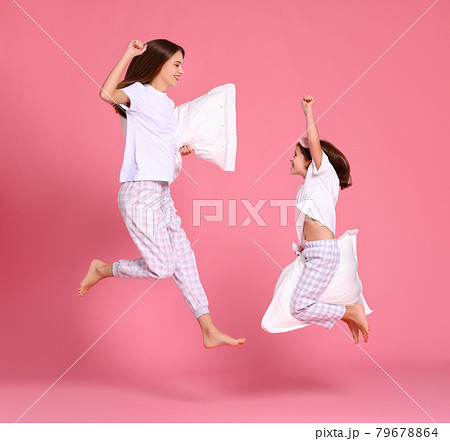 Excited mother and daughter jumping in morning 79678864