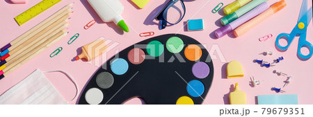 School supplies flat lay with medical mask. Stationery on pink color background, top view, copy space. Education, Back to School, kids creativity concept.Banner 79679351