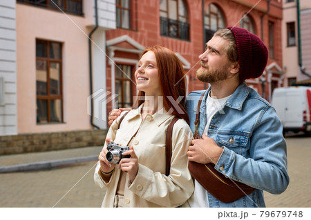 Tourism and technology. Happy young couple taking photo of old town. Traveling by Europe. Tourism and technology. Happy young couple taking photo of old town. Traveling by Europe. 79679748