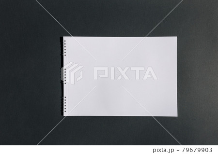 Piece of white album paper on black. 79679903