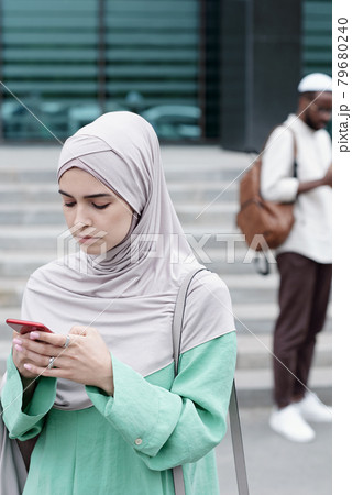 Muslim Businesswoman Ordering Taxi 79680240