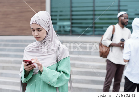 Muslim Woman Checking Phone 79680241