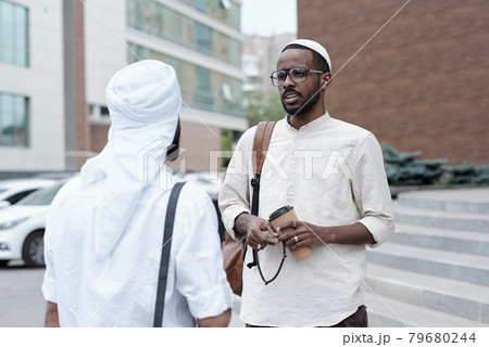 Muslim Man Drinking Coffee With Business Partner Muslim Man Drinking Coffee With Business Partner 79680244