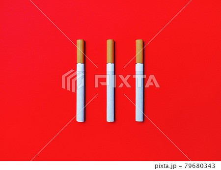 Three cigarettes on red Three cigarettes on red 79680343