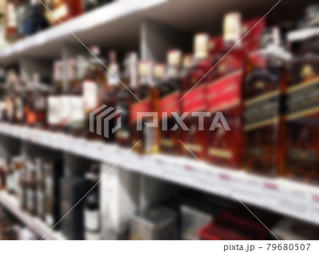 Alcohol showcase blurred background. Blurred abstract background of shelf in supermarket 79680507
