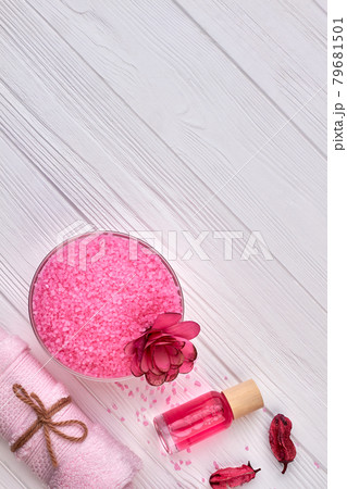 Vertical shot pink salt with perfume and rolled towel. 79681501