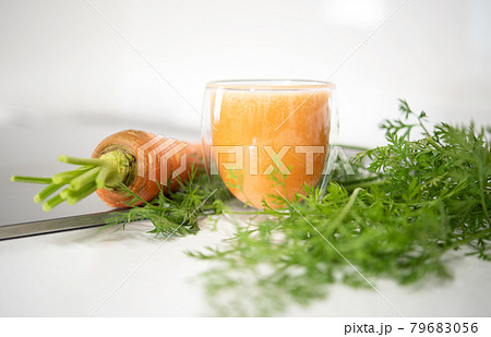 Fresh organic carrot juice in glass isolated on mable countertop. Healthy food 79683056