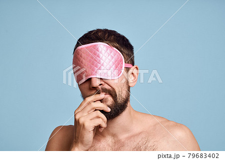 Emotional bearded man in a mask for sleeping blue background close-up Emotional bearded man in a mask for sleeping blue background close-up 79683402