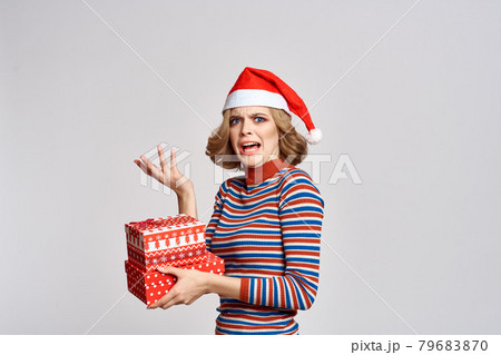 happy woman with christmas gifts in hands and red hat on head new year holidays cropped view happy woman with christmas gifts in hands and red hat on head new year holidays cropped view 79683870