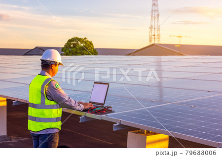 The engineer is checking the solar cell photovoltaic power station system on rooftop. The engineer is checking the solar cell photovoltaic power station system on rooftop. 79688006