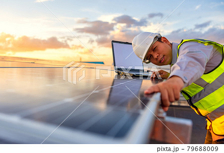 The engineer is checking the solar cell photovoltaic power station system on rooftop. 79688009