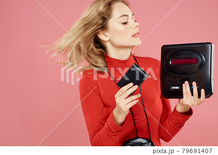 Woman with video game attachment lifestyle entertainment lifestyle pink background Woman with video game attachment lifestyle entertainment lifestyle pink background 79691407