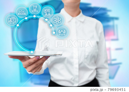 Lady In Uniform Standing Holding Tablet In Hand Presenting Virtual Modern Technology. Business Woman Carrying Tab Pointing For New Futuristic Tech. 79693451