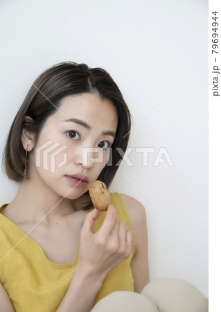 おやつを食べる女性 79694944