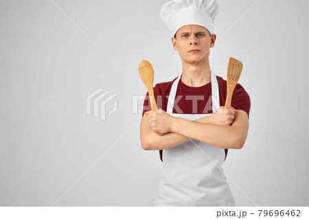 a man with a ladle in his hands cooking a professional chef's job 79696462