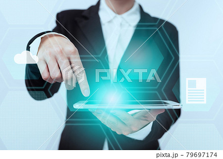 Lady In Suit Standing Pointing On Tablet Showing Futuristic Graphic Interface. Woman In Uniform Holding Mobile Device Presenting Modern Virtual Technologies. 79697174