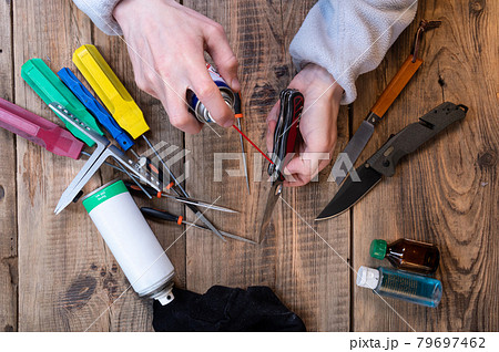 Cleaning a pocket knife. Lubricate the pocket knife. Caring for knives. Tool service and repair. The master greases the knife. 79697462