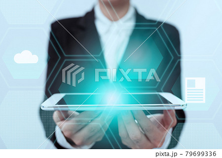 Lady In Uniform Standing Holding Touchpad With Two Hands Showing Futuristic Interface. Woman In Suit Carrying Tablet Displaying Modern Virtual Technology. 79699336