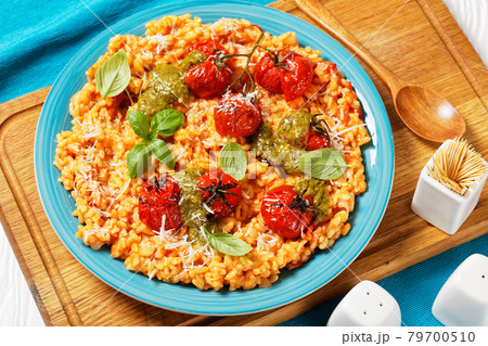 creamy tomato risotto with pesto, top view 79700510