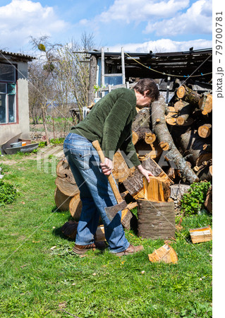 Man pricks wood with an ax 79700781