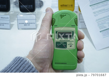 Customer hand holding personal dosimeter-radiometers for measuring levels of radiation Customer hand holding personal dosimeter-radiometers for measuring levels of radiation 79701687