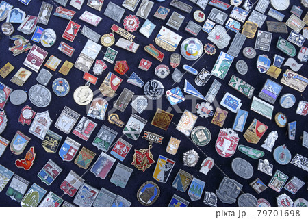 Pile of an old Soviet USSR pins medals badges placed on a tray for sale. Flea market Pile of an old Soviet USSR pins medals badges placed on a tray for sale. Flea market 79701698