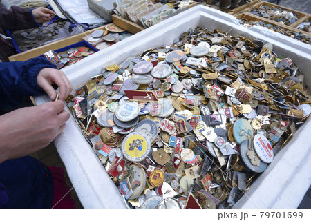 Pile of an old Soviet USSR pins medals badges placed on a tray for sale. Flea market 79701699