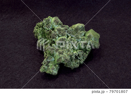 Clouse-up of green malachite mineral from the Urals, Russia, on a plum background 79701807