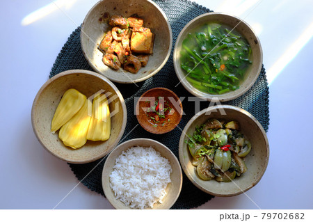 Vietnamese vegan food, rice bowl, fried aubergine, seitan cook with sauce, spinach soup Vietnamese vegan food, rice bowl, fried aubergine, seitan cook with sauce, spinach soup 79702682