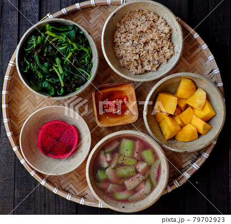 Frugal meal with vegetarian food, vegetable, soup, fried rice, mango 79702923