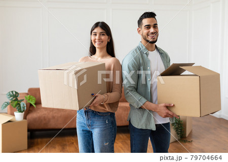 Happy man and woman holding cardboard boxes Happy man and woman holding cardboard boxes 79704664