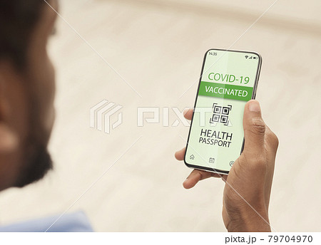 Black man using smartphone with digital health passport for covid-19 Black man using smartphone with digital health passport for covid-19 79704970