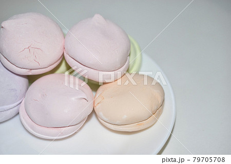 Colorful delicious marshmallows on a white plate Colorful delicious marshmallows on a white plate 79705708